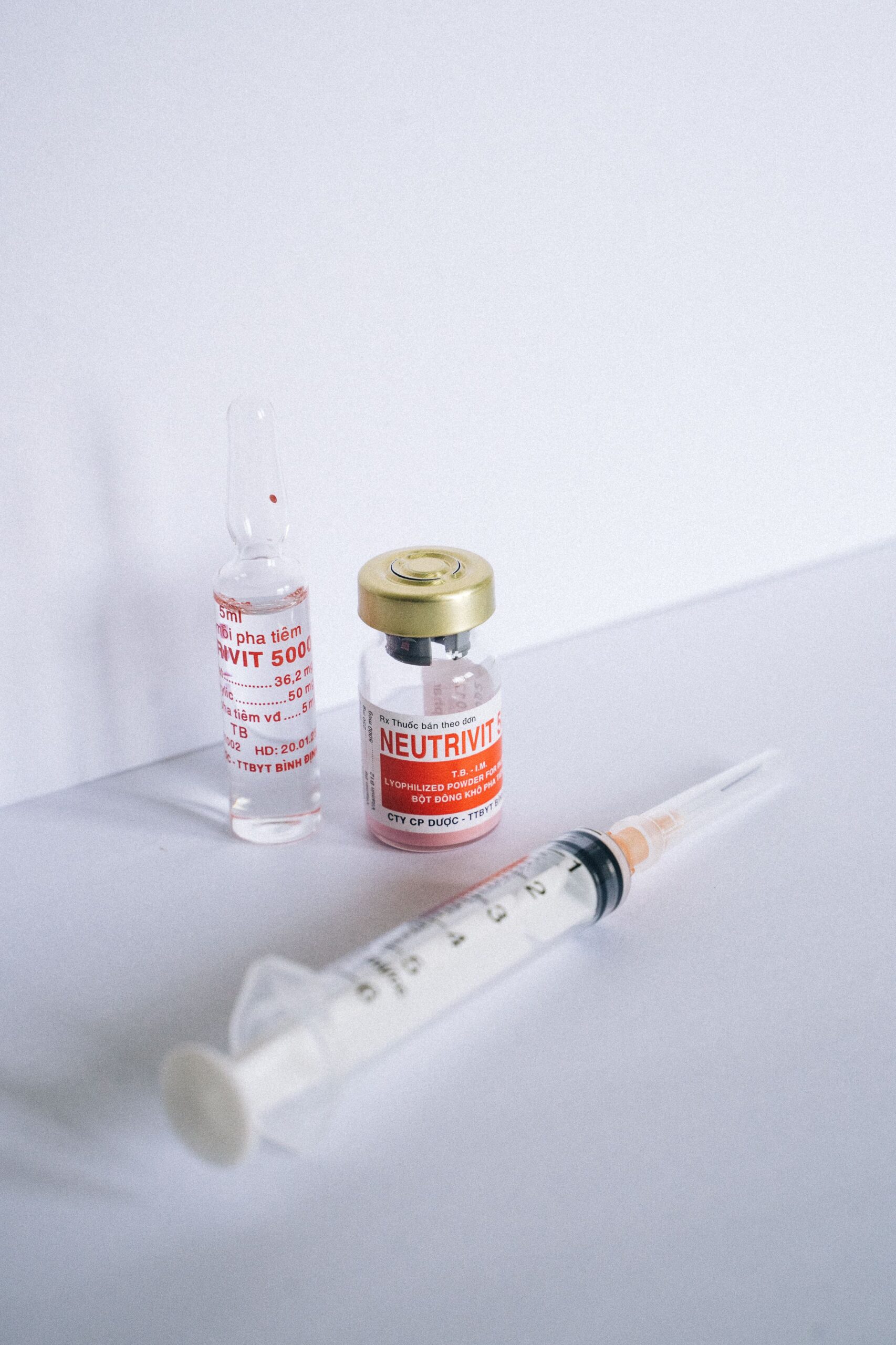 Veterinary vaccination syringe and vaccine bottles used to protect dogs before attending daycare, training and overnight boarding.